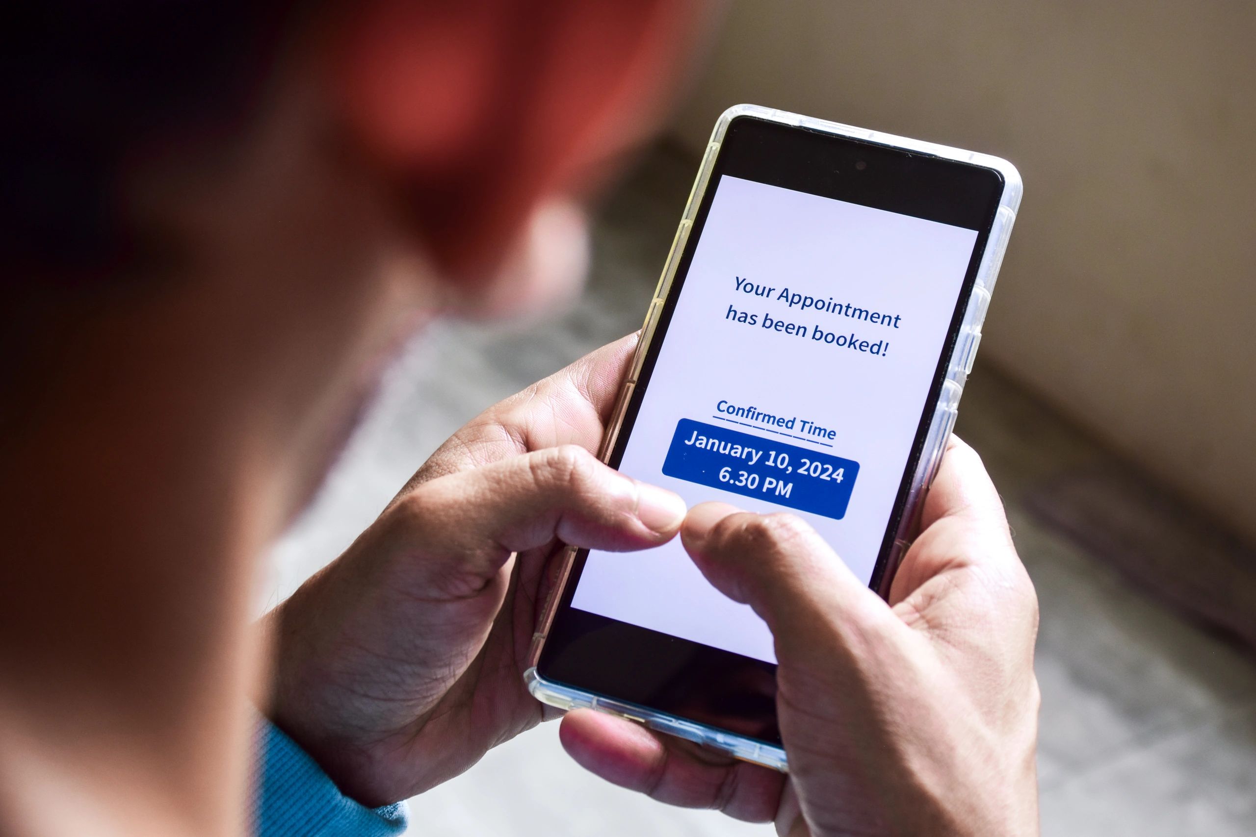 Customer checking a smartphone appointment notification for mobile car service